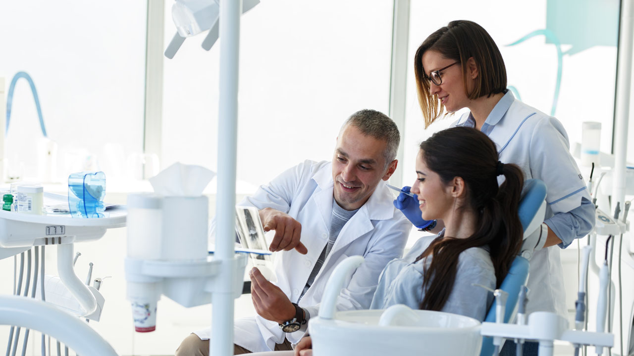 male dentist explaining result to his patient